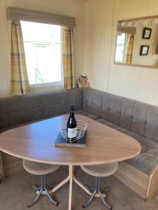 a table with a bottle of wine on top of it at 367 Caravan in Stevenston