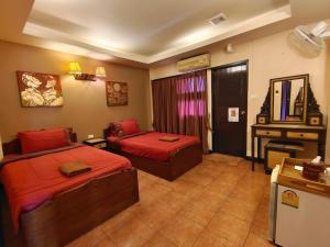 a bedroom with two beds and a desk in it at Wualai Boutique by Lanna Oriental in Chiang Mai +23 photos