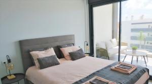 a bedroom with a large bed and a balcony at Casa de Valentino in Villamartin