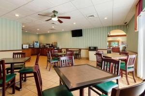 a restaurant with tables and chairs and a ceiling fan at Best Western Staunton Inn in Staunton