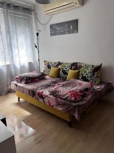 a bed in a living room with a couch at Apartment Lili in Blagoevgrad