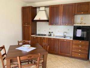 a kitchen with wooden cabinets and a wooden table at Villa Gianna in Limone sul Garda