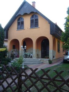 a house with a fence in front of it at Almavilla in Gyenesdiás