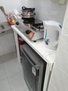 una pequeña cocina con fogones y fregadero en Golden Nest, en Mombasa