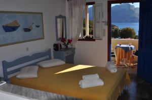 a bedroom with a bed with two towels on it at Fotini Studios in Emborios Kalymnos