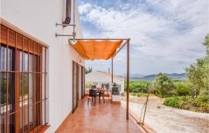 - une vue extérieure sur une maison avec un parasol orange dans l'établissement Awesome Home In Estepa With Wifi, à Estepa