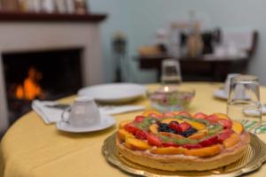 a table with a cake with fruit on it at B&B Stupor Mundi in Altamura