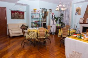 a living room with a table and chairs and a couch at B&B Stupor Mundi in Altamura