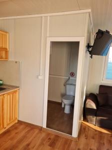 a bathroom with a toilet in a small room at Rich Avdira Beach in Ávdhira
