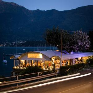 a lit up building on the side of a road at Locanda dei pescatori in Domaso