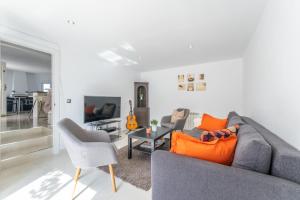 a living room with a gray couch and chairs at Modern villa with great location in Ciudad Quesada