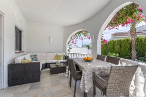 a living room with a table and chairs at Modern villa with great location in Ciudad Quesada