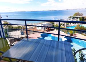 a balcony with a table and a view of the water at Vega Village Ap B39 in Sveti Vlas