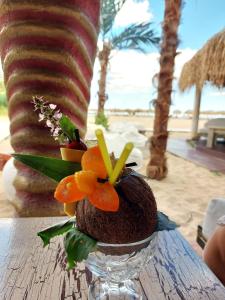 a coconut with fruit on a table at a beach at Vega Village Ap B39 in Sveti Vlas