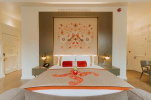 a bedroom with a large bed with a dragon on it at The LaLit London in London