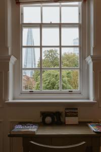 a window with a view of the burj khalifa seen through it at The LaLit London in London