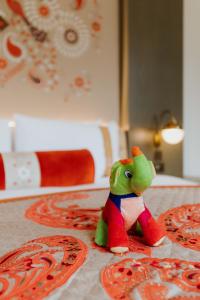 a toy frog sitting on top of a table at The LaLit London in London