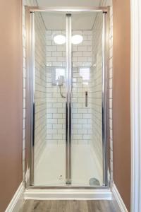 a shower with a glass door in a bathroom at Veyron Apartments - part of the V Group in Blackpool