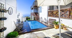 a swimming pool in the middle of a house at Penguins View Guesthouse in Simonʼs Town