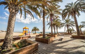a park with palm trees and a playground at Amazing Apartment In Torreblanca With 3 Bedrooms in Torreblanca