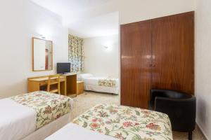 Postel nebo postele na pokoji v ubytování Hotel Leuka