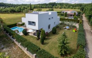 an aerial view of a white house with a swimming pool at Villa Kate Istria in Žminj