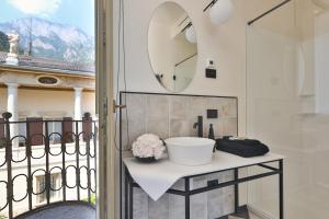 a bathroom with a sink and a mirror on a balcony at Villa Sizzo Relais B&B in Trento