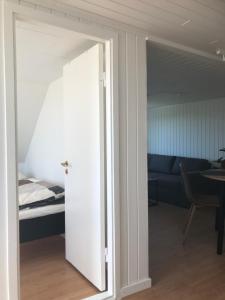 a door leading into a bedroom with a bed at Seaside Top in Thisted