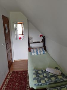a small room with a bed and a mirror at B&B Jonovic in Donji Milanovac