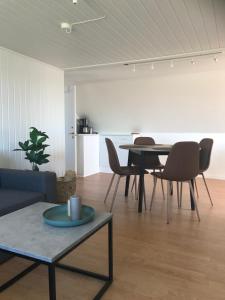 a living room with a table and chairs at Seaside Top in Thisted