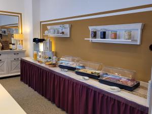a buffet line with food on it in a room at Hotel Brockenscheideck in Schierke