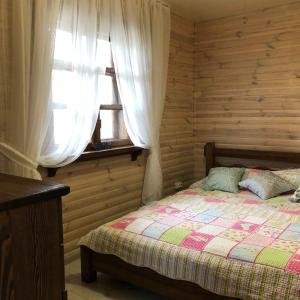 Strizhevka的住宿－Дом для отдыха Lake House，一间卧室设有一张床和一个窗口