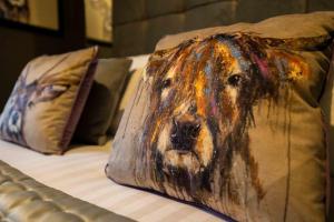 a pillow with a dog face on a bed at Regent Road by the V Group in Blackpool