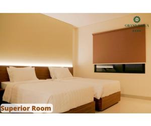 A bed or beds in a room at Grand Papua Hotel Sentani