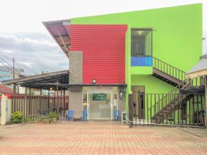 a brightly colored building with a red and green at Hotel Lido 88 Sorong Mitra RedDoorz in Sorong