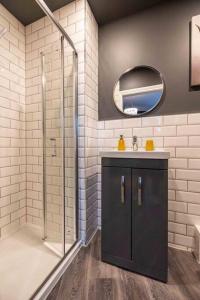 a bathroom with a shower and a sink and a mirror at Regent Road by the V Group in Blackpool