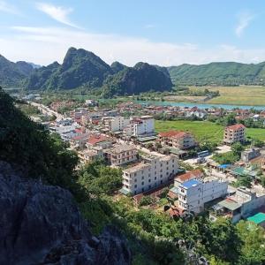 a view of a city with mountains in the background at Song Toan Hotel in Phong Nha