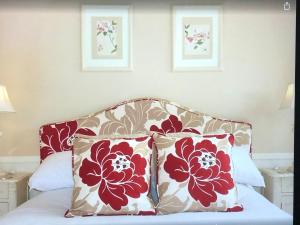 two pillows sitting on top of a bed in a room at Cransley Apart Hotel in Bournemouth