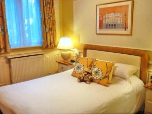 a bedroom with a bed with a teddy bear on it at Cransley Hotel in Bournemouth