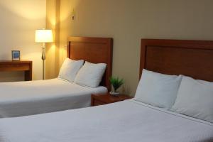Postel nebo postele na pokoji v ubytování Hotel Marllou