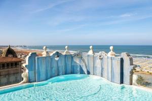 a swimming pool with a water slide on the beach at Grand Hotel Principe Di Piemonte in Viareggio