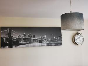 a clock hanging on a wall next to a bridge at City Centre Penthouse in Southampton