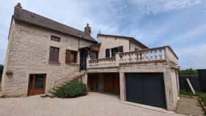 a large brick house with a large garage at Le panorama des Hautes-Côtes in Fussey