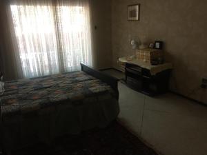 a bedroom with a bed and a desk and window at Room in Guest room - Property located in a quiet area close to the train station and town in Casablanca