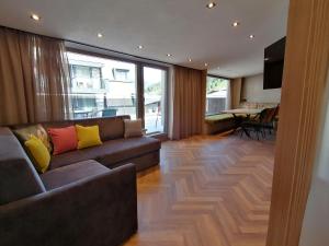 a living room with a couch and a table at Haus Marion Haueis in Sankt Anton am Arlberg