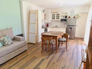 a kitchen and living room with a table and chairs at Apart Esperanza in Esperanza