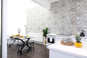 a kitchen and dining room with a brick wall at ALTIDO Lovely 4 bed house, private garden and free parking in Edinburgh