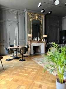 uma sala de jantar com uma mesa e uma lareira em Luxueux 2 pièces 65m2 Hôtel Particulier XVII ième siècle-Centre Historique Clermont-Ferrand em Clermont-Ferrand