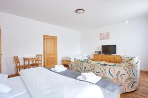 a living room with two beds and a couch at Resort Pasečná in Přední Výtoň