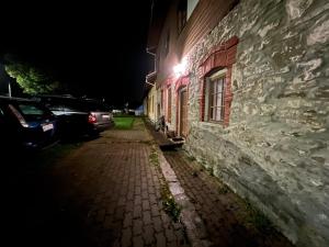 a building with a light on the side of it at night at Apartmán Penziónu Hrubjak in Oravská Polhora